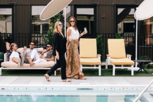 Guests enjoying a cocktail from the bar at Paseo by the pool at the Myriad Hotel