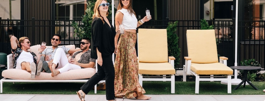 Guests enjoying a cocktail from the bar at Paseo by the pool at the Myriad Hotel