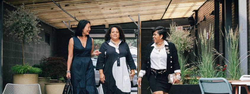 Employees smiling in the outdoor section of Paseo Restaurant