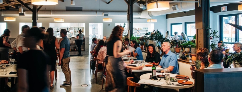 Waitress takes orders at Paseo restaurant in the Myriad Hotel.
